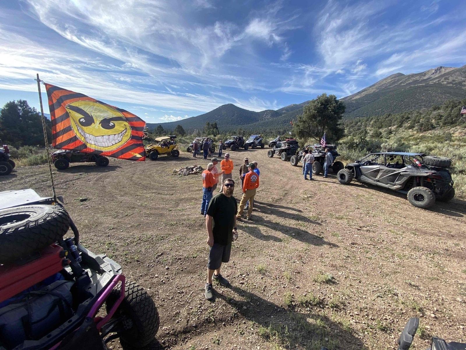 Riders gathering with mountains in the background