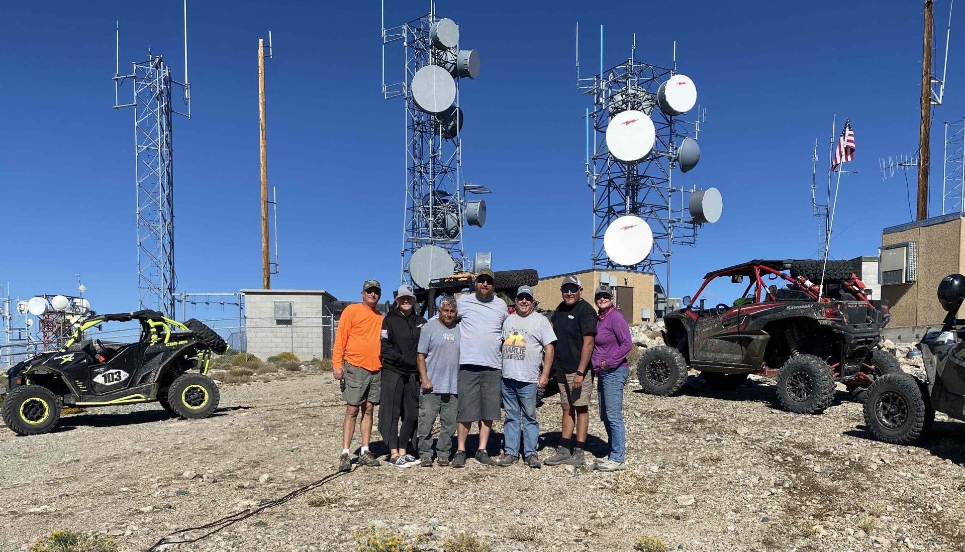 Group of riders celebrating at a mountain summit